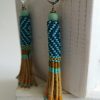 Boucles d'oreilles tissées, Héritage